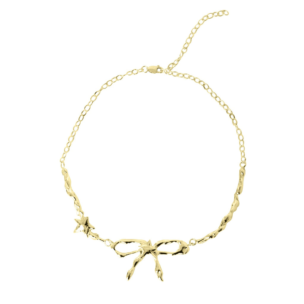 Gold bracelet with branch-like design on a white background