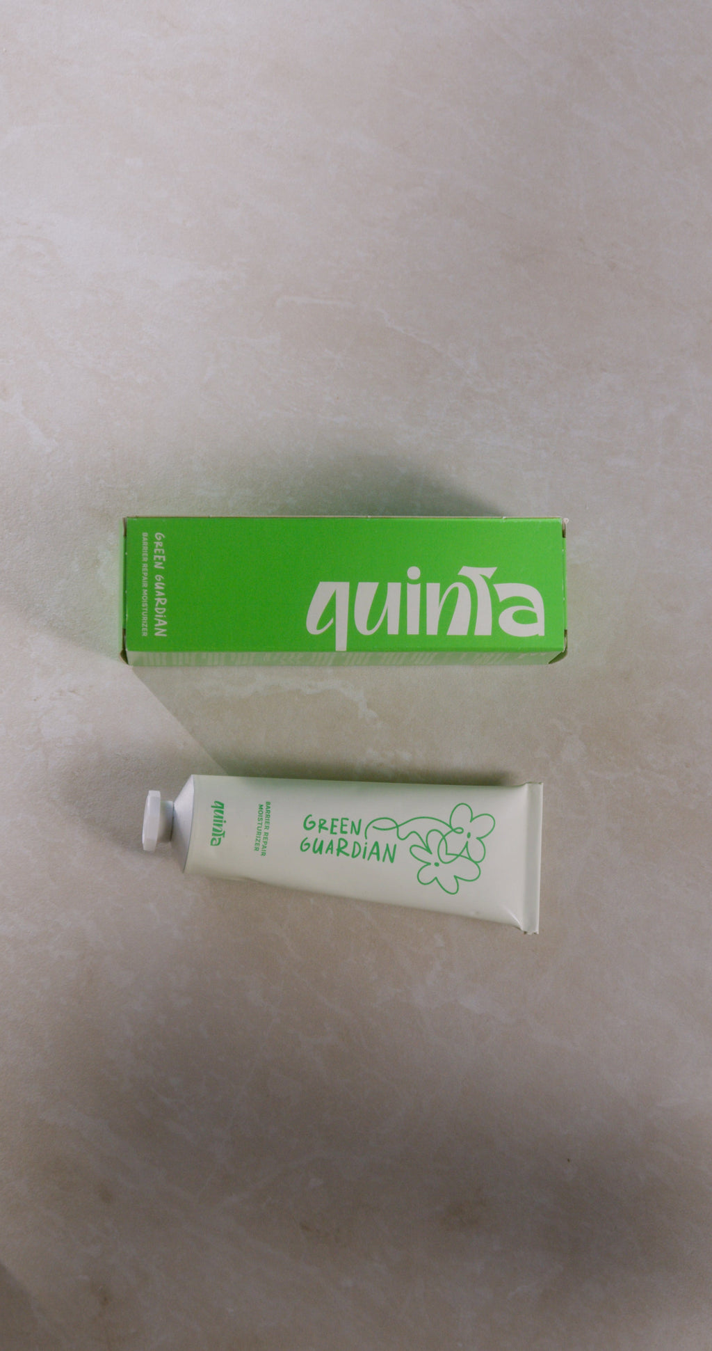 Quinta green guardian product with packaging on a beige background